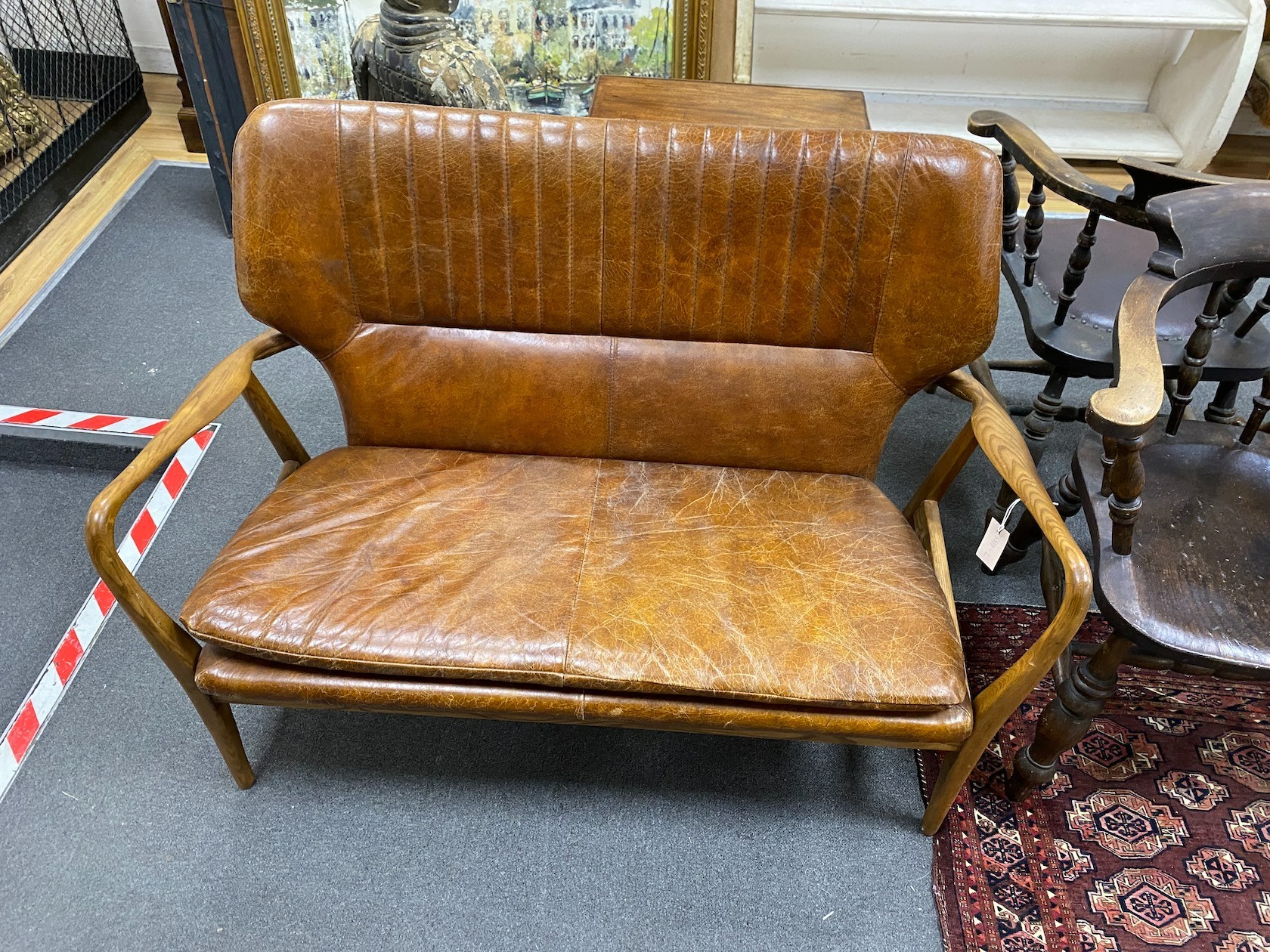 A Laura Ashley Whitworth oak and leather sofa, length 121cm, width 60cm, height 87cm